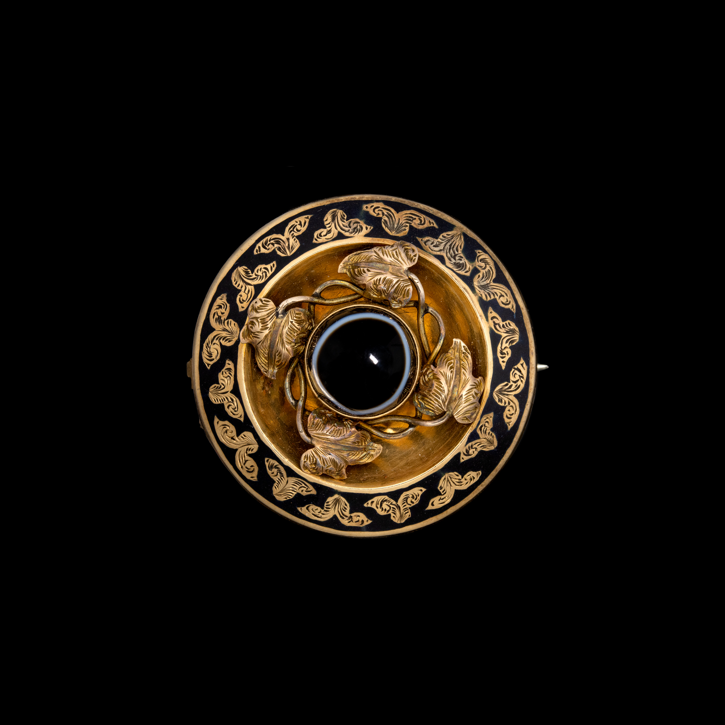 A gorgeous Victorian gold and enamel mourning brooch set with an agate.